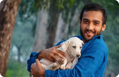 A volunteer holding a rescued puppy