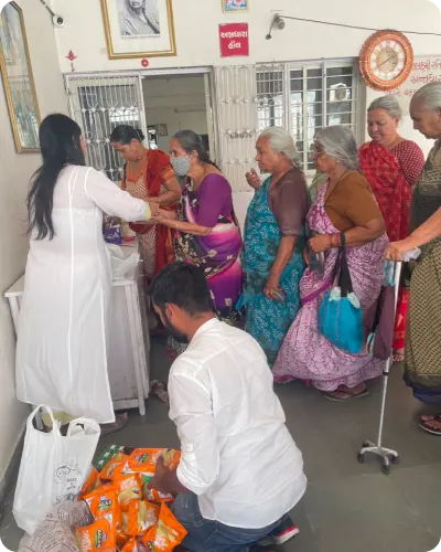 Enrise volunteers distributing care supplies to women at a community center
